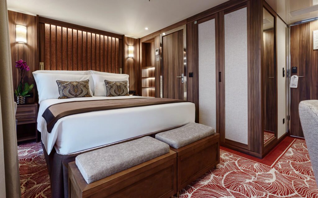 Luxurious bedroom with elegant wooden accents and plush bedding.