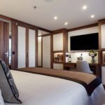 Elegant hotel room with a large bed and modern amenities.