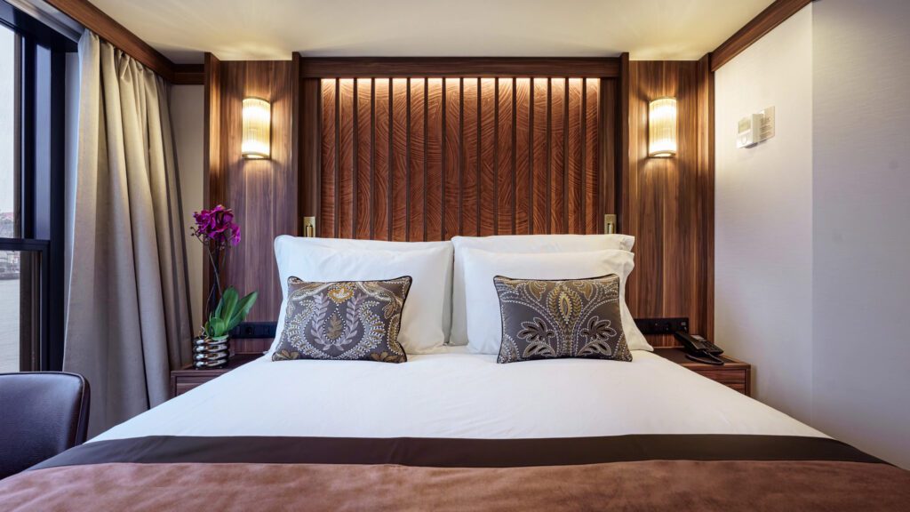 Luxurious bedroom with elegant pillows and warm lighting.