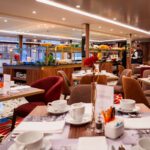 Cozy restaurant dining area with neatly set tables and warm lighting.