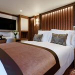 Cozy hotel room with a plush bed and elegant decor.