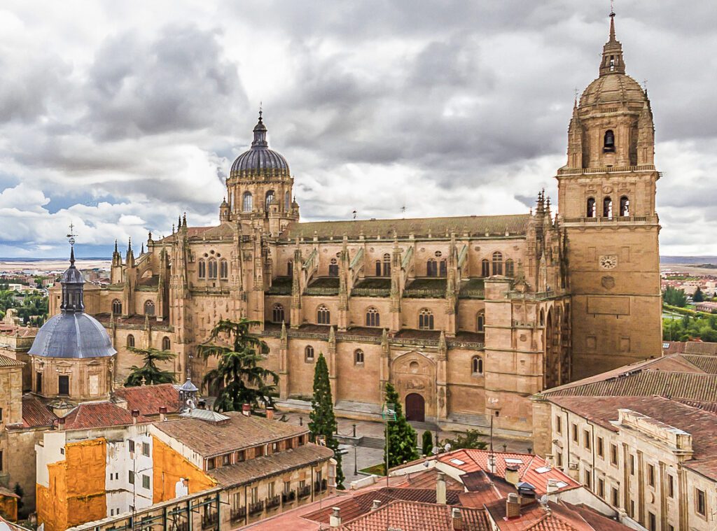 Historic cathedral with intricate architecture under a cloudy sky.