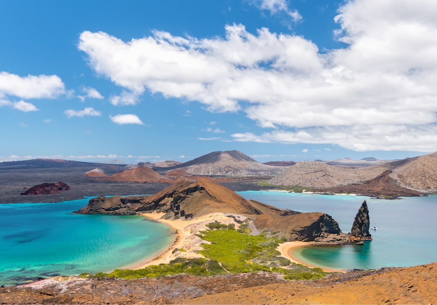 Scenic view of rocky islands and turquoise waters under a blue sky.
